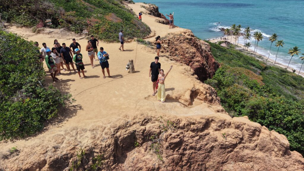 Passeio off-road de quadriciclo levantando poeira nas trilhas de terra vermelha da Costa do Conde.